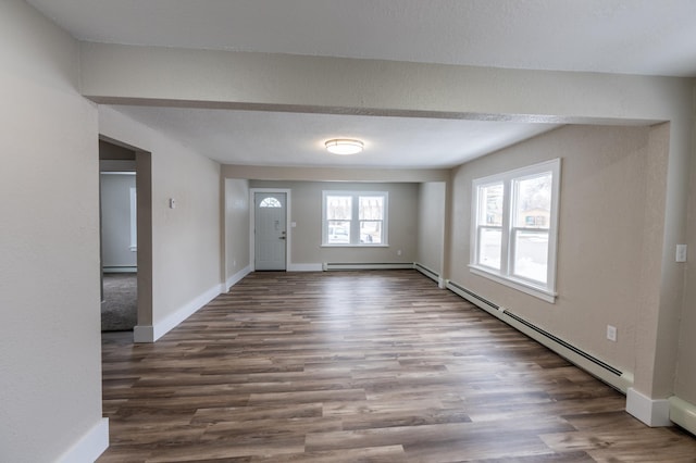 foyer entrance with a baseboard radiator, wood finished floors, a baseboard heating unit, and baseboards