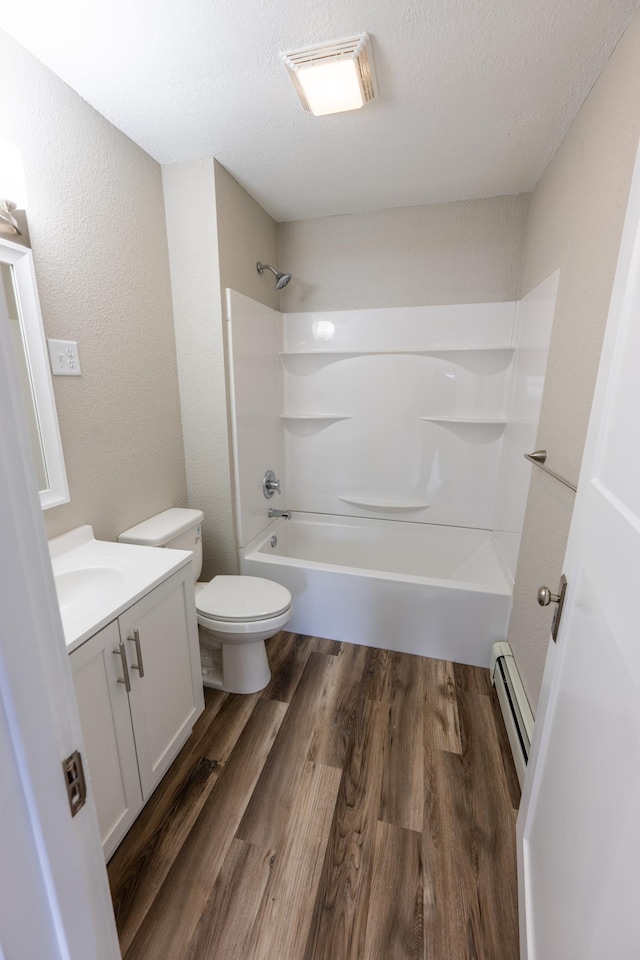 bathroom featuring vanity, toilet, shower / bath combination, wood finished floors, and a baseboard radiator