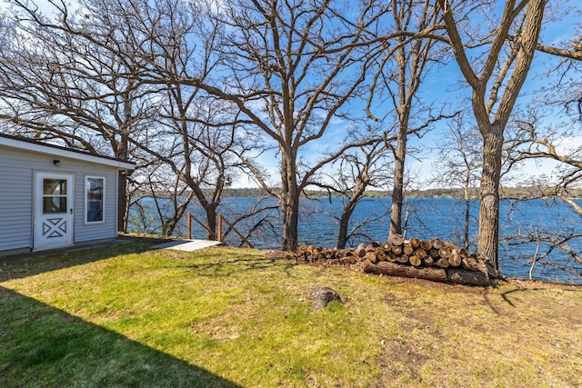 view of yard with a water view and an outbuilding