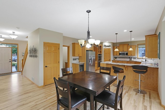 27130 Hickory Ridge Dr, Elko New Market, MN 55020 - dining room featuring visible vents, baseboards, light wood finished floors, and a chandelier