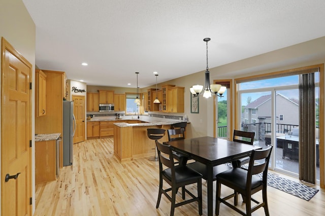 27130 Hickory Ridge Dr, Elko New Market, MN 55020 - dining room with recessed lighting, a notable chandelier, light wood-style floors, and a healthy amount of sunlight