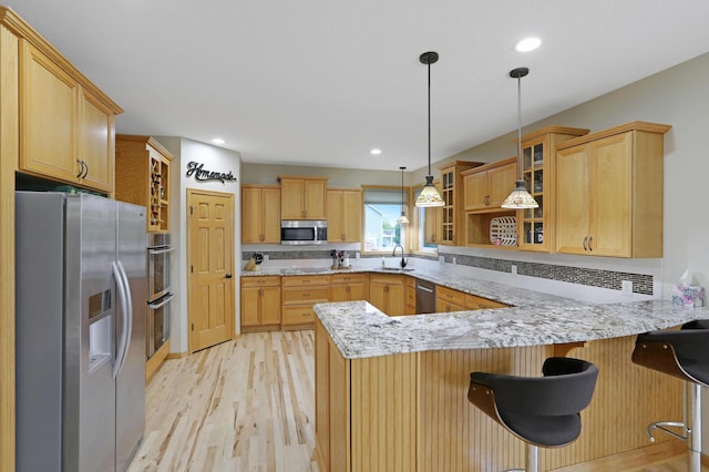 27130 Hickory Ridge Dr, Elko New Market, MN 55020 - kitchen with light wood-style floors, glass insert cabinets, a peninsula, a sink, and stainless steel appliances