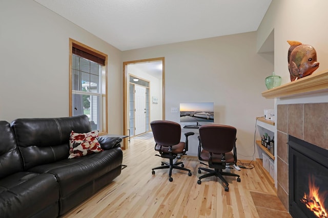 27130 Hickory Ridge Dr, Elko New Market, MN 55020 - office featuring a tiled fireplace and light wood finished floors