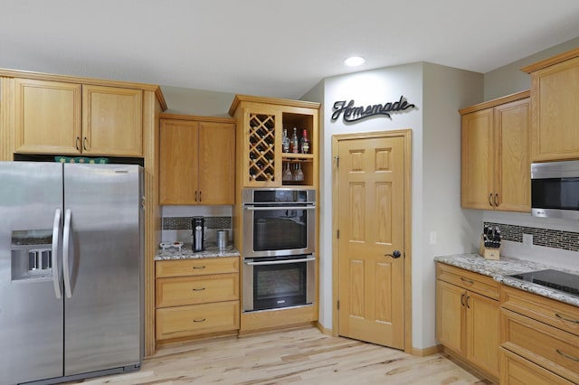 27130 Hickory Ridge Dr, Elko New Market, MN 55020 - kitchen featuring light stone countertops, decorative backsplash, light wood finished floors, appliances with stainless steel finishes, and light brown cabinetry