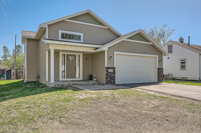 view of front of property with driveway, an attached garage, and a front yard