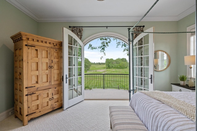 carpeted bedroom with golf course view, access to outside, french doors, and ornamental molding