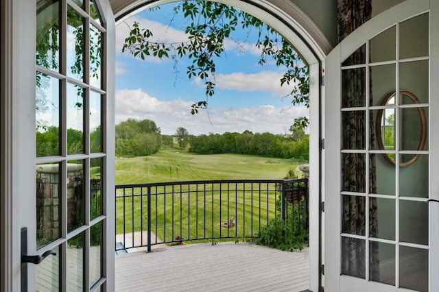 entryway featuring view of golf course and a wealth of natural light