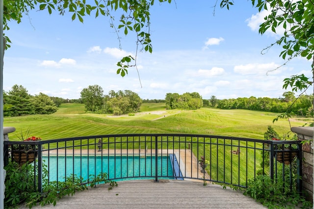 exterior space featuring golf course view, a yard, and a fenced in pool