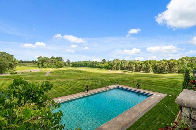 outdoor pool featuring a lawn