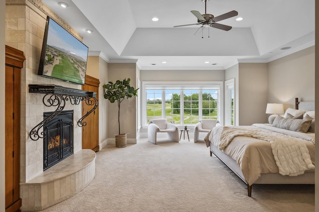 bedroom featuring a raised ceiling, a fireplace, crown molding, carpet floors, and recessed lighting