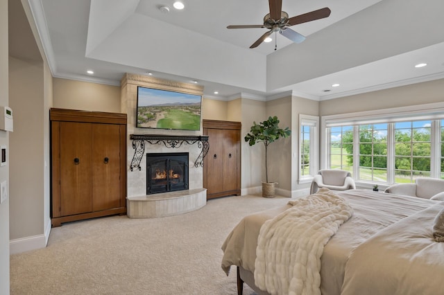 carpeted bedroom with a tiled fireplace, ornamental molding, baseboards, and recessed lighting