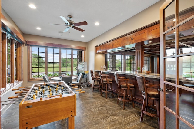 rec room featuring ceiling fan, recessed lighting, and bar area
