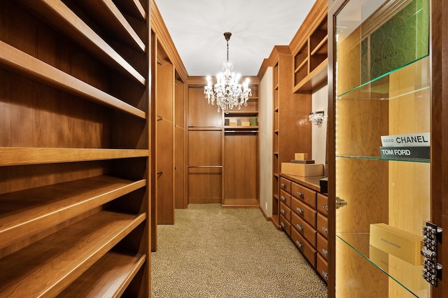 walk in closet featuring light colored carpet and an inviting chandelier