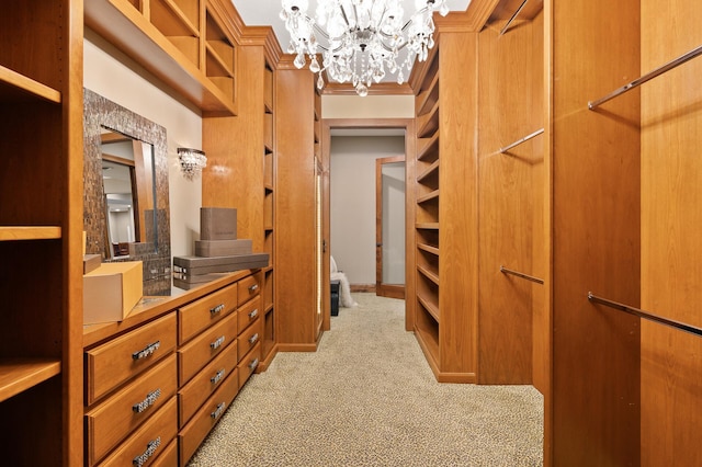 walk in closet featuring carpet flooring and a chandelier