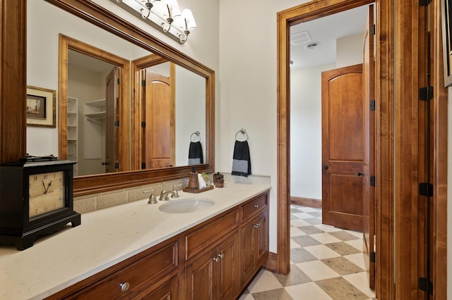 bathroom featuring tile patterned floors, vanity, and baseboards