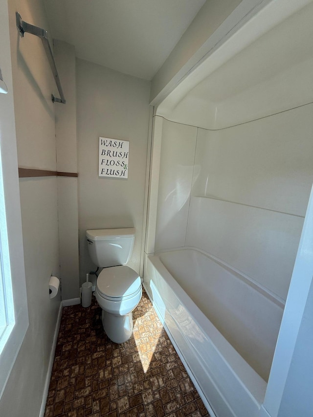 full bath featuring toilet and baseboards