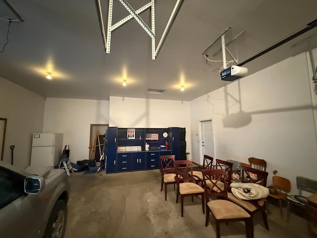 20343 680th Ave, Alden, MN 56009 - garage with freestanding refrigerator and a garage door opener