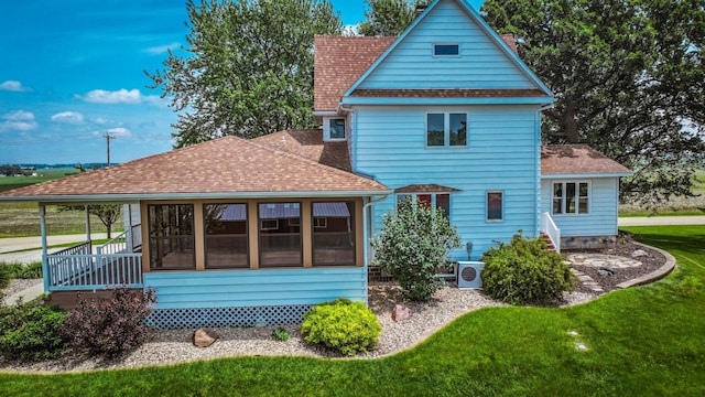 20343 680th Ave, Alden, MN 56009 - rear view of house featuring a sunroom, roof with shingles, and a lawn
