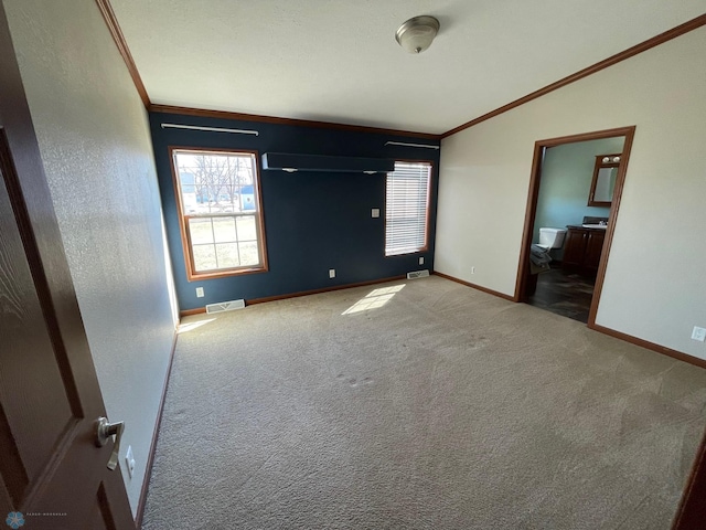 535 5th St, Wyndmere, ND 58081 - unfurnished bedroom with crown molding, multiple windows, and visible vents