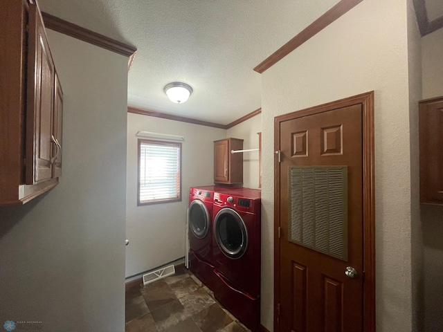 535 5th St, Wyndmere, ND 58081 - laundry room with a textured ceiling, crown molding, visible vents, cabinet space, and washing machine and clothes dryer