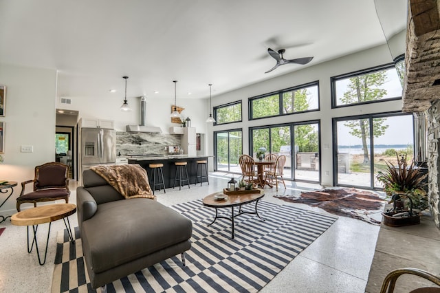 4681 Mission Rd NE, Sugar Bush Twp, MN 56601 - living room with a ceiling fan, dark aggregate flooring, recessed lighting, and a high ceiling