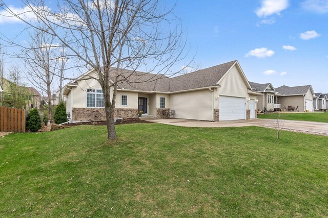 ranch-style home with fence, an attached garage, a front lawn, brick siding, and concrete driveway