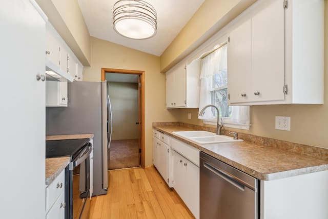 kitchen with stainless steel dishwasher, black / electric stove, a sink, light wood-style flooring, and vaulted ceiling