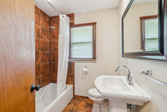 bathroom featuring healthy amount of natural light, baseboards, toilet, shower / bath combo with shower curtain, and a textured ceiling