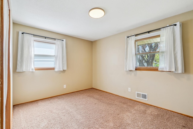 spare room with carpet and baseboards