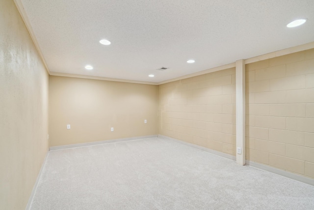 finished basement featuring recessed lighting, carpet, baseboards, and a textured ceiling