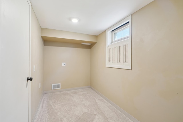 below grade area featuring baseboards and carpet flooring