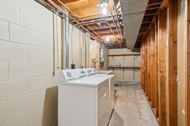 laundry room featuring separate washer and dryer and concrete block wall