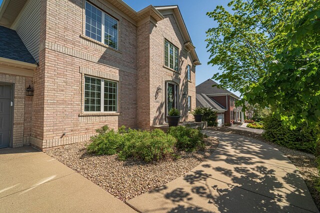 view of property exterior featuring brick siding