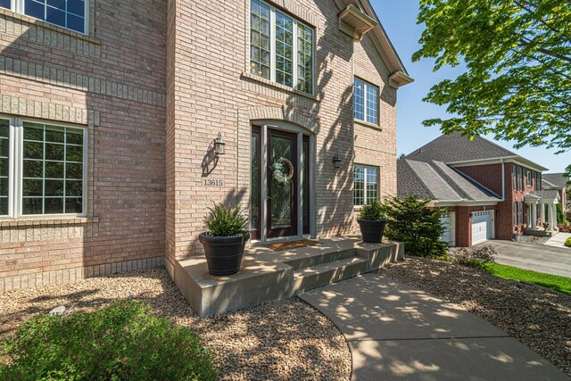 property entrance featuring brick siding