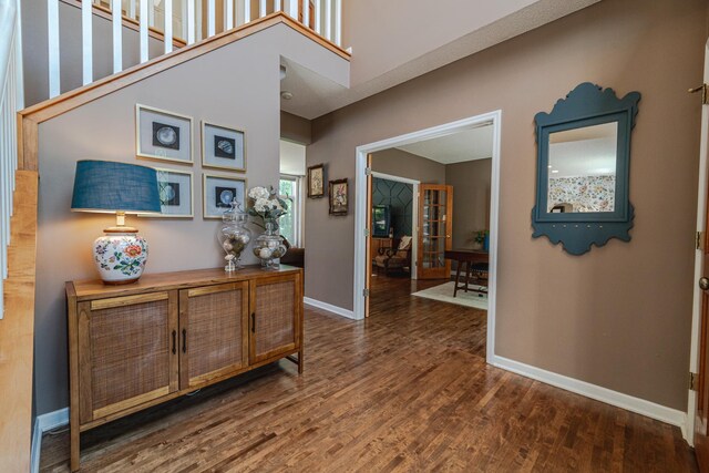 hallway featuring baseboards and wood finished floors