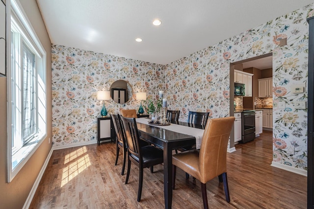 dining area with wallpapered walls, baseboards, wood finished floors, and recessed lighting