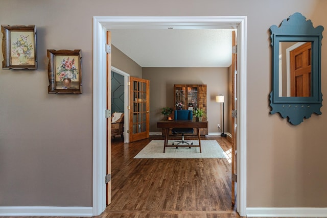 home office with dark wood-style floors, french doors, and baseboards