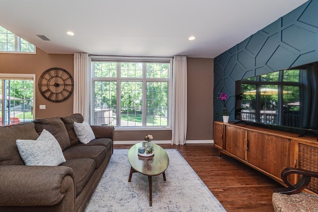 living room featuring dark wood-type flooring, plenty of natural light, baseboards, and recessed lighting