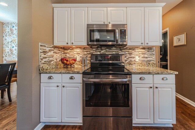 kitchen featuring stainless steel appliances, dark wood-type flooring, white cabinetry, baseboards, and decorative backsplash