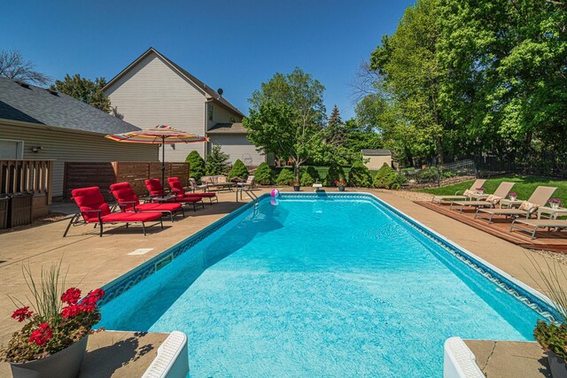 view of pool featuring a patio and fence