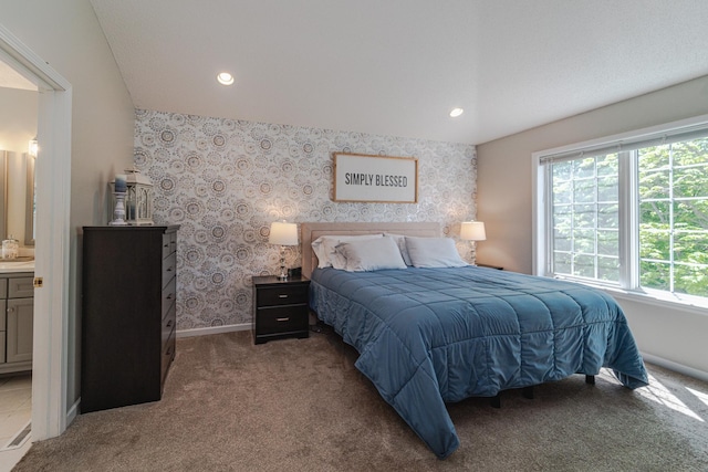 bedroom featuring carpet floors, baseboards, recessed lighting, wallpapered walls, and ensuite bath