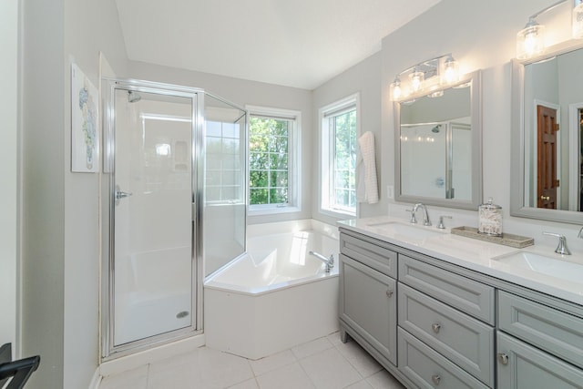 full bathroom featuring a stall shower, a bath, double vanity, and tile patterned floors