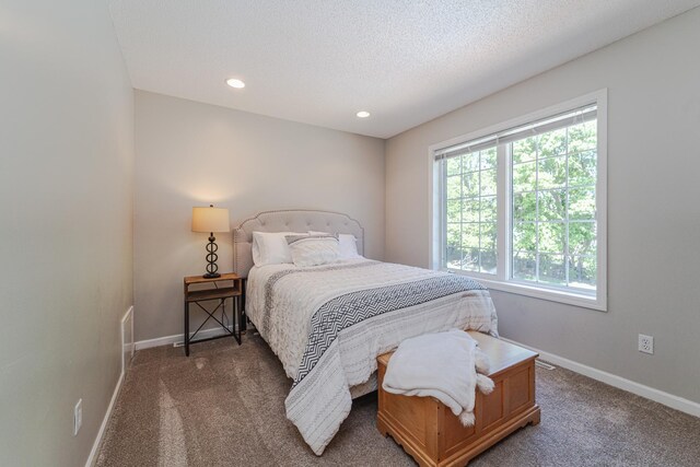 carpeted bedroom featuring baseboards, recessed lighting, and a textured ceiling