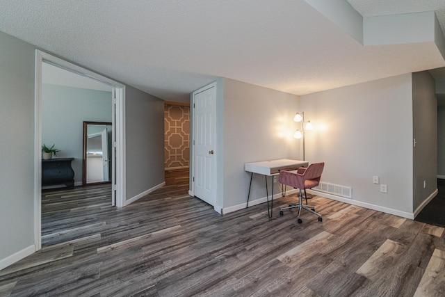 office space with wood finished floors, a textured ceiling, and baseboards