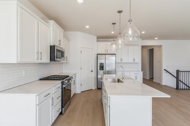 kitchen featuring a sink, decorative backsplash, appliances with stainless steel finishes, and recessed lighting