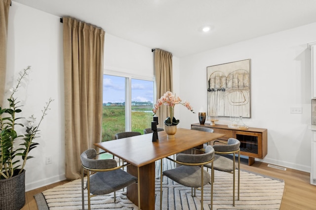 dining area with light wood-type flooring, baseboards, recessed lighting, and visible vents