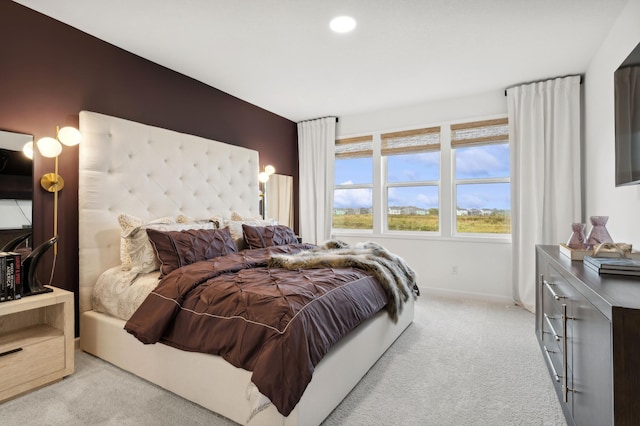 carpeted bedroom featuring baseboards and recessed lighting