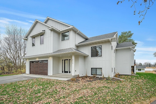 modern farmhouse with board and batten siding, an attached garage, a shingled roof, and driveway