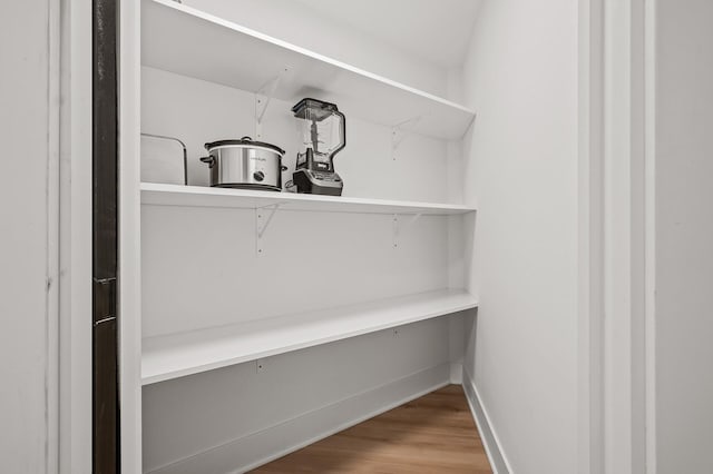 interior details featuring wood finished floors and baseboards