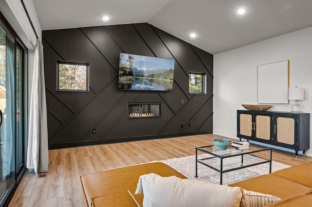 living room with light wood-type flooring, recessed lighting, and lofted ceiling